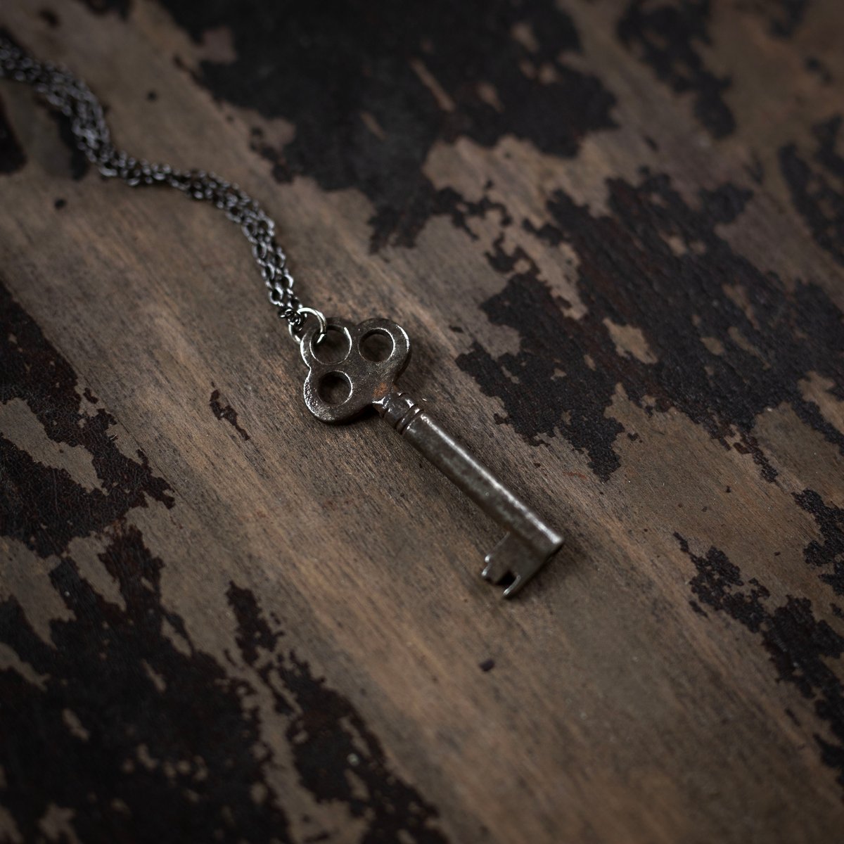 Skeleton key with three holes on gunmetal chain