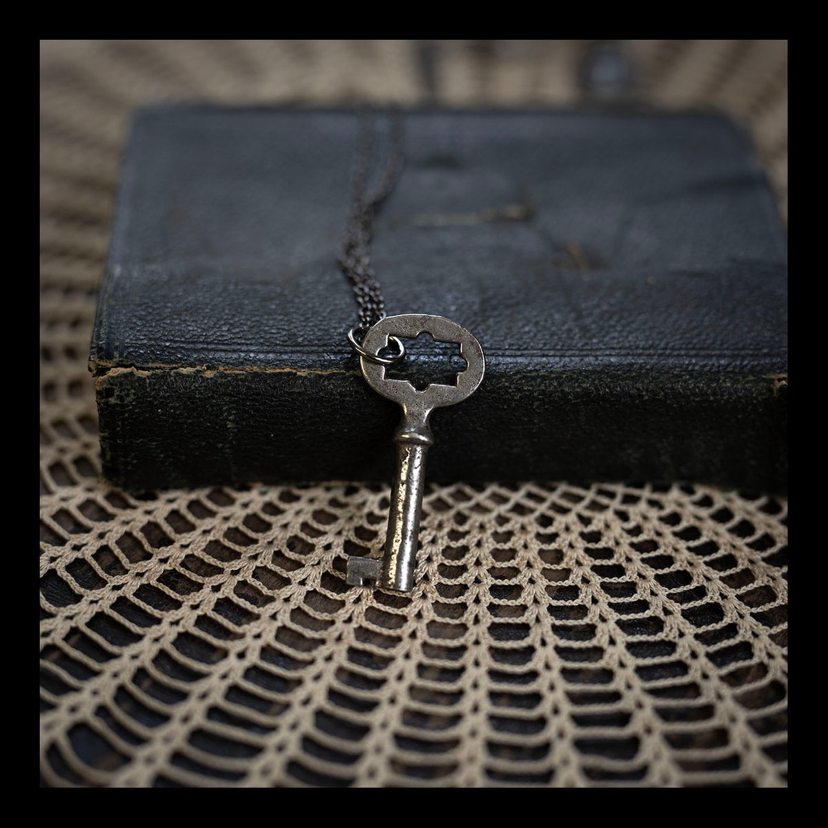 Small sunburst skeleton key on gunmetal chain