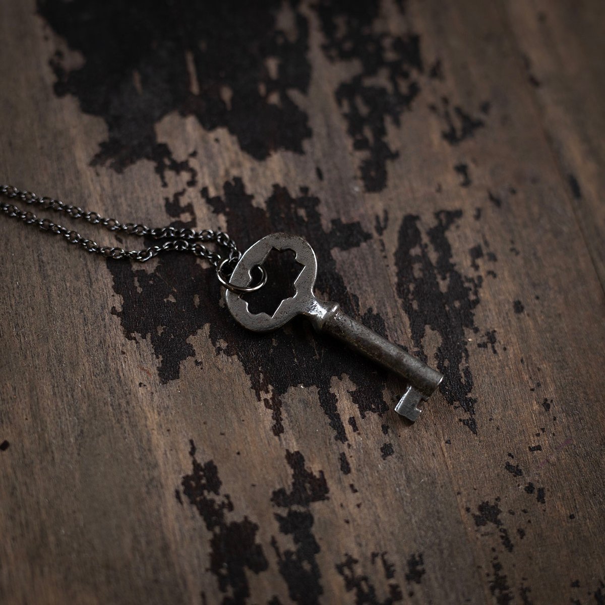 Small sunburst skeleton key on gunmetal chain