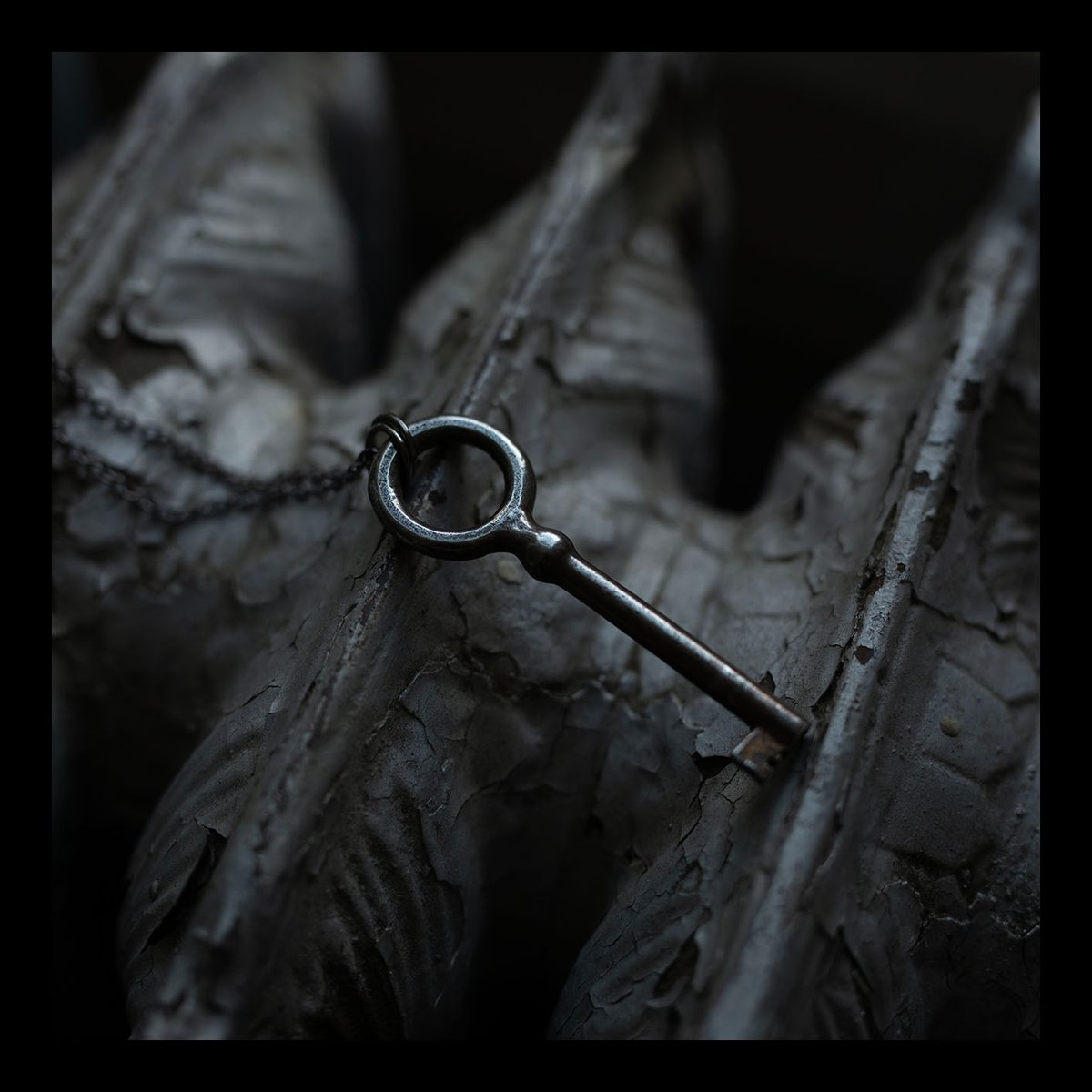 Large circular skeleton key on gunmetal chain