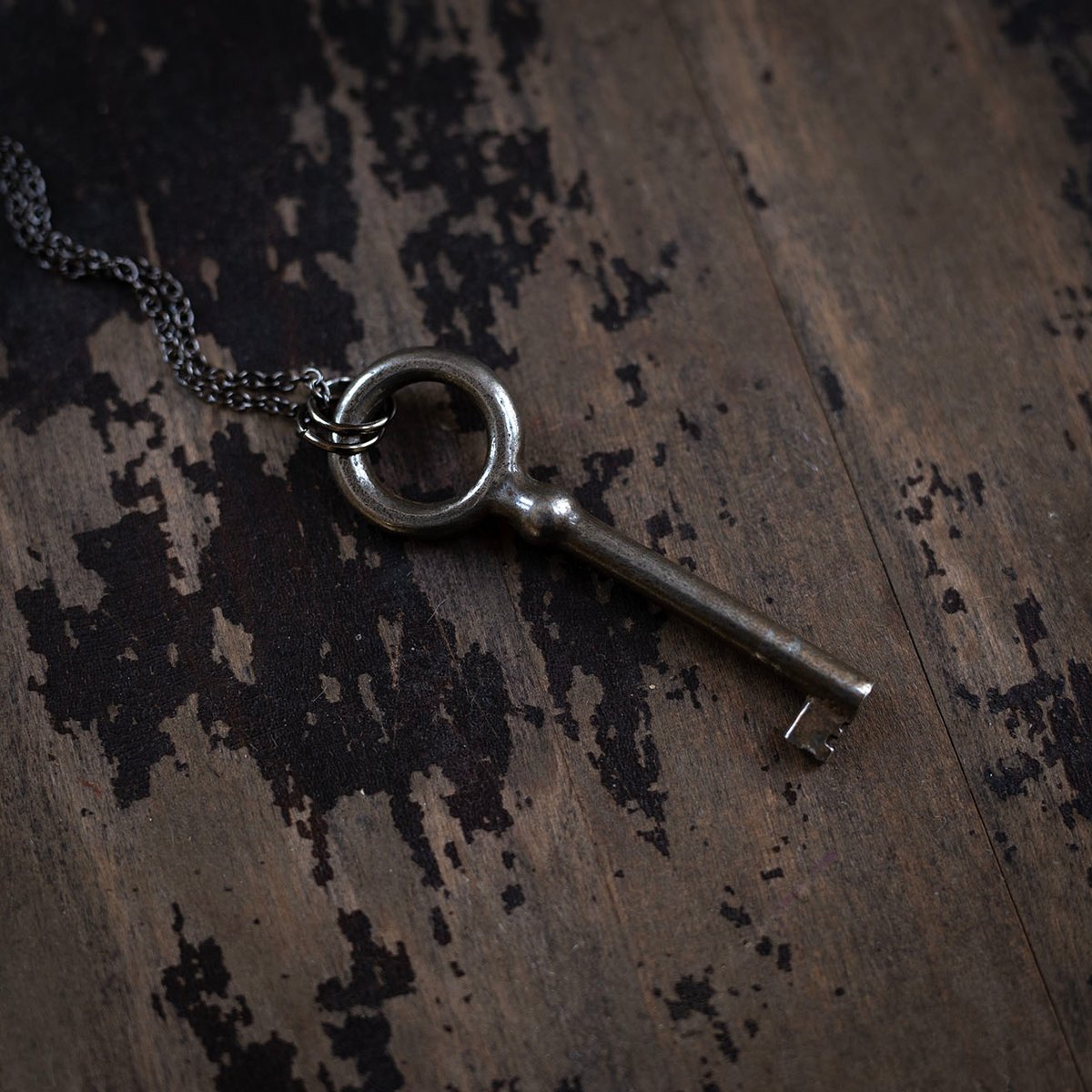 Large circular skeleton key on gunmetal chain