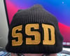 Black New Era Knit beanie hat with Solid Gold SSD logo 