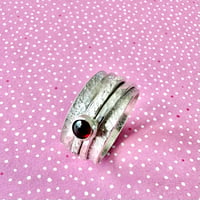 Image 2 of Sterling Silver Raw Silk Texture Spinner Ring with a Garnet