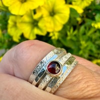 Image 1 of Sterling Silver Raw Silk Texture Spinner Ring with a Garnet