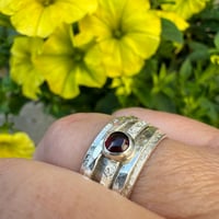 Image 4 of Sterling Silver Raw Silk Texture Spinner Ring with a Garnet