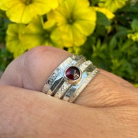 Image 3 of Sterling Silver Raw Silk Texture Spinner Ring with a Garnet