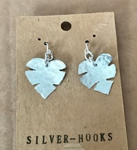 Image 2 of Cheese plant leaf earrings.