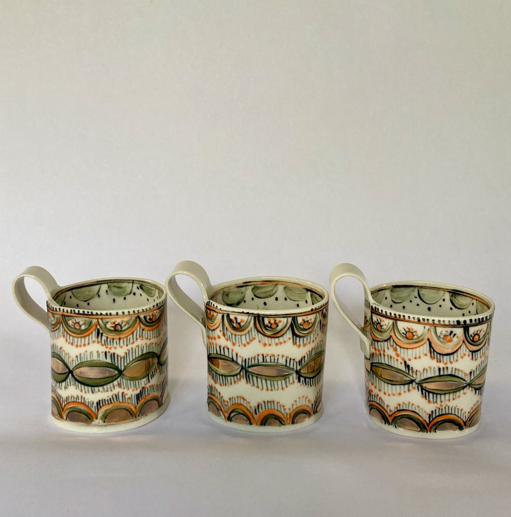 Image of Coffee cups orange and gold