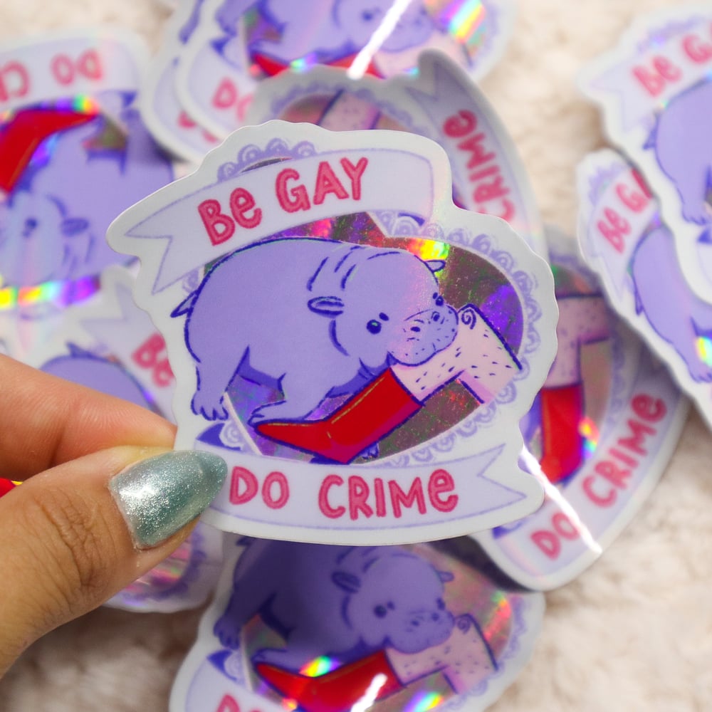 Image of Be Gay Do Crime Holographic Pygmy Hippo Sticker