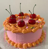 Image 1 of Festive Glittery/ Sparkle Cake for display/ fake cake/ orange and pink cake/ red cherries/fake fo...