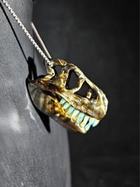 Image 2 of Electrum T-rex skull pendant with wood glue teeth.