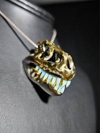 Image 1 of Electrum T-rex skull pendant with wood glue teeth.