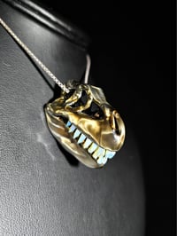 Image 2 of Electrum T-rex skull pendant with wood glue teeth..