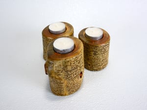 Image of Set of three Spruce wood tea light candle holders with natural markings