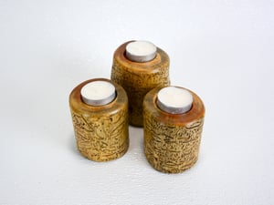 Image of Set of three Spruce wood tea light candle holders with natural markings