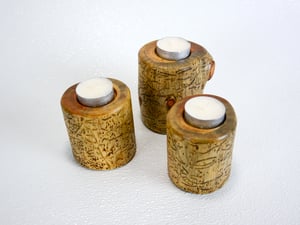 Image of Set of three Spruce wood tea light candle holders with natural markings