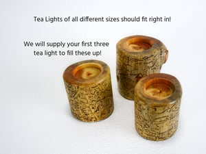 Image of Set of three Spruce wood tea light candle holders with natural markings