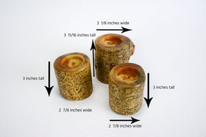 Image of Set of three Spruce wood tea light candle holders with natural markings