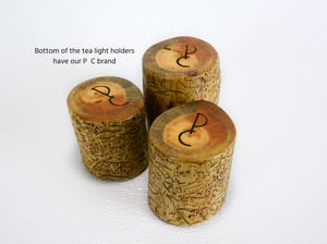 Image of Set of three Spruce wood tea light candle holders with natural markings