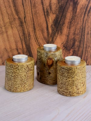 Image of Set of three Spruce wood tea light candle holders with natural markings