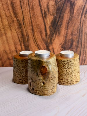Image of Set of three Spruce wood tea light candle holders with natural markings