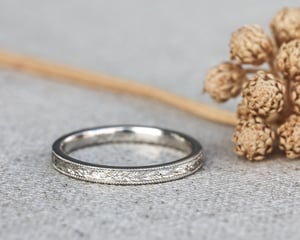 Image of Platinum 2mm flat court, laurel leaf and milled edge engraved ring