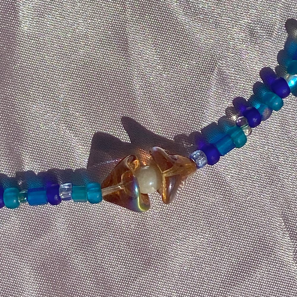 Image of sea shell necklaces (white center)