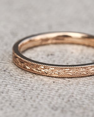 Image of 18ct rose gold, 2mm flat court, laurel leaf and milled edge engraved ring