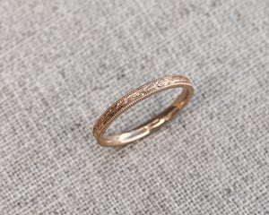 Image of 18ct rose gold, 2mm flat court, laurel leaf and milled edge engraved ring