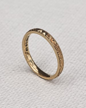 Image of 18ct Yellow gold, 2mm flat court, Floral and milled edge engraved ring