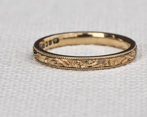 Image of 18ct Yellow gold, 2mm flat court, Floral and milled edge engraved ring