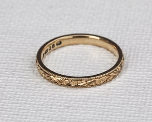 Image of 18ct Yellow gold, 2mm flat court, Floral and milled edge engraved ring