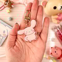 Image 5 of Acrylic Glitter Pink Cinna Cinnamon Roll Puppy Keychain