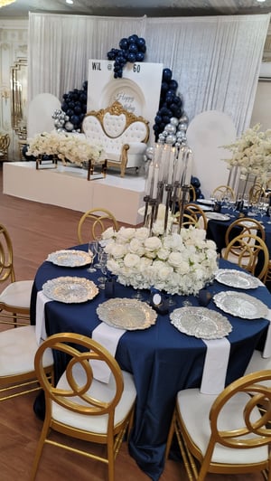 Image of Silver candlelabra with flowers at the base 