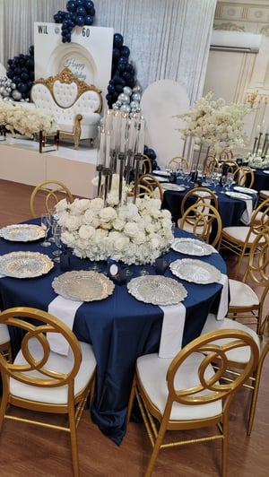 Image of Silver candlelabra with flowers at the base 