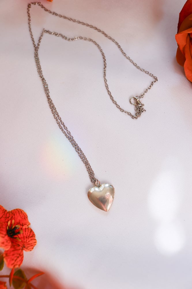 Image of Vintage Small Silver Sweetheart Locket With Bow and Floral Details