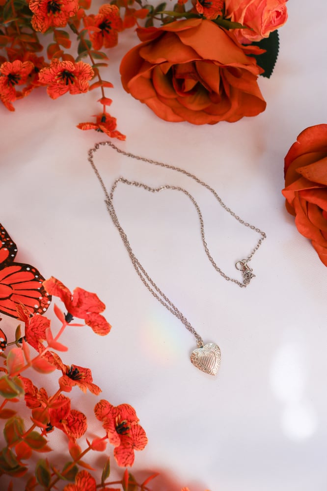 Image of Vintage Small Silver Sweetheart Locket With Bow and Floral Details