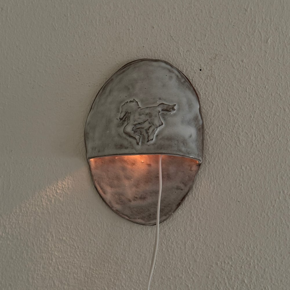 Image of white horse sconce