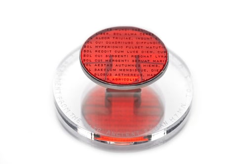 Image of "A fragment from Late Ancient Roman hymn to Sun.." silver ring with red acrylic glass 45mm