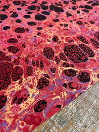 Image 3 of 'Molten Rock' // one-of-a-kind hand marbled paper on red base paper 