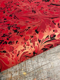 Image 1 of 'Fiery Swirl' // one-of-a-kind hand marbled paper on red 