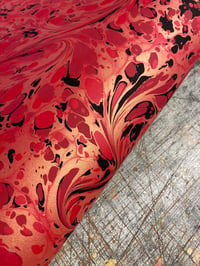 Image 2 of 'Fiery Swirl' // one-of-a-kind hand marbled paper on red 