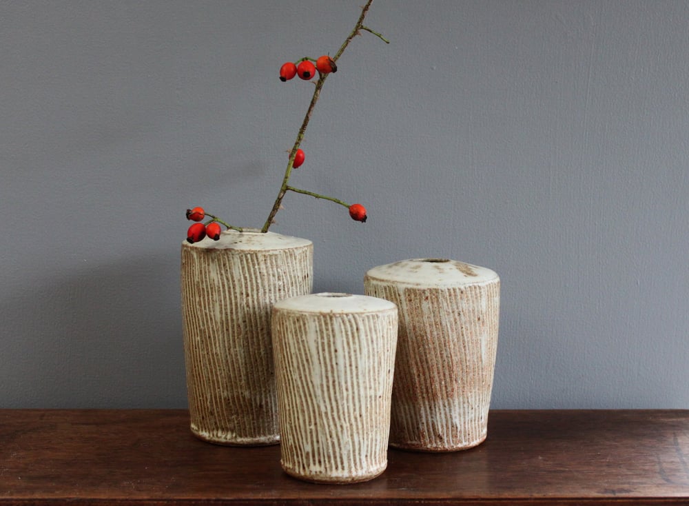 Image of Incised set of three stem Vases. 