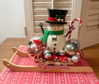 Image 1 of So Jolly Wooden Snowman On Sled with Lots of Christmas Sparkle