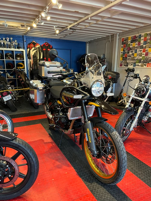 Image of 2024 Himalayan 450 in Hanle Black displayed with the optional Adventure Kit