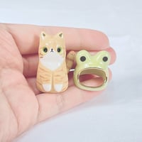 Image 4 of Orange cat with frog hat ceramic figurine