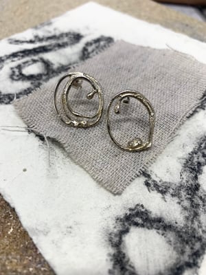 Image of "Circle Around Each Other" molten silver earrings