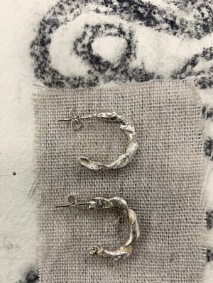 Image of "The Centre Cannot Hold" molten silver hoops
