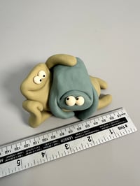 Image 10 of Green thing laying on brown thing