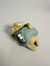 Image 6 of Green thing laying on brown thing